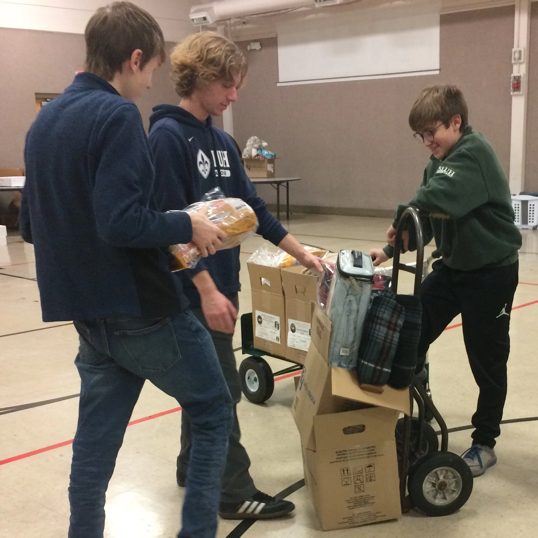 High school sodalists working at a food drive